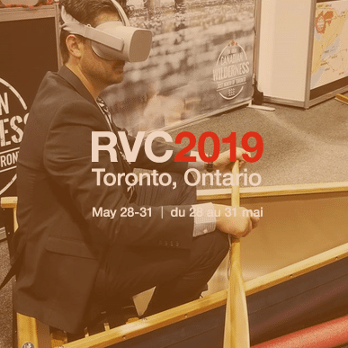 A man wearing a VR headset in a canoe at the Rendez-vous Canada trade show in 2019