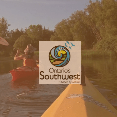 Video production still of kayakers on the Thames River with logo for Ontario's Southwest