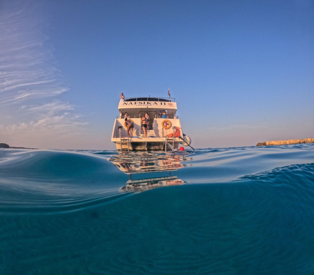 Tour boat on clear blue water seen from water level
